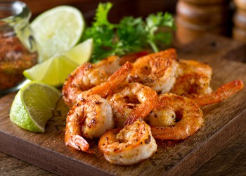 Delicious sauteed shrimp with cajun seasoning and lime on a maple plank.