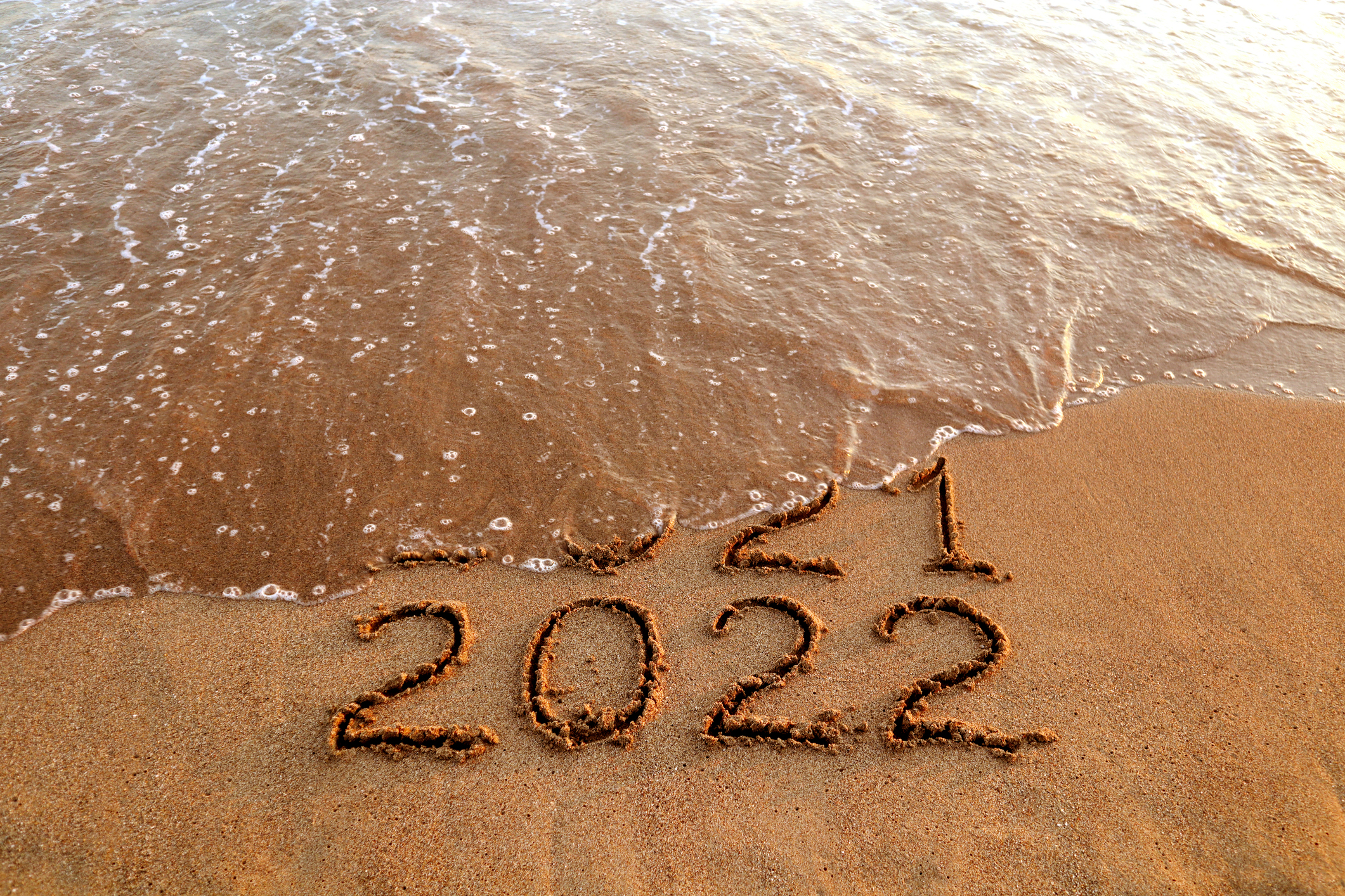 New year 2022 and old year 2021 on sandy beach with waves Hamptons