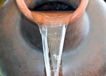 Close up Pour water out of terracotta pots. Understand kenosis