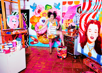 Ashley Longshore with several of her paintings