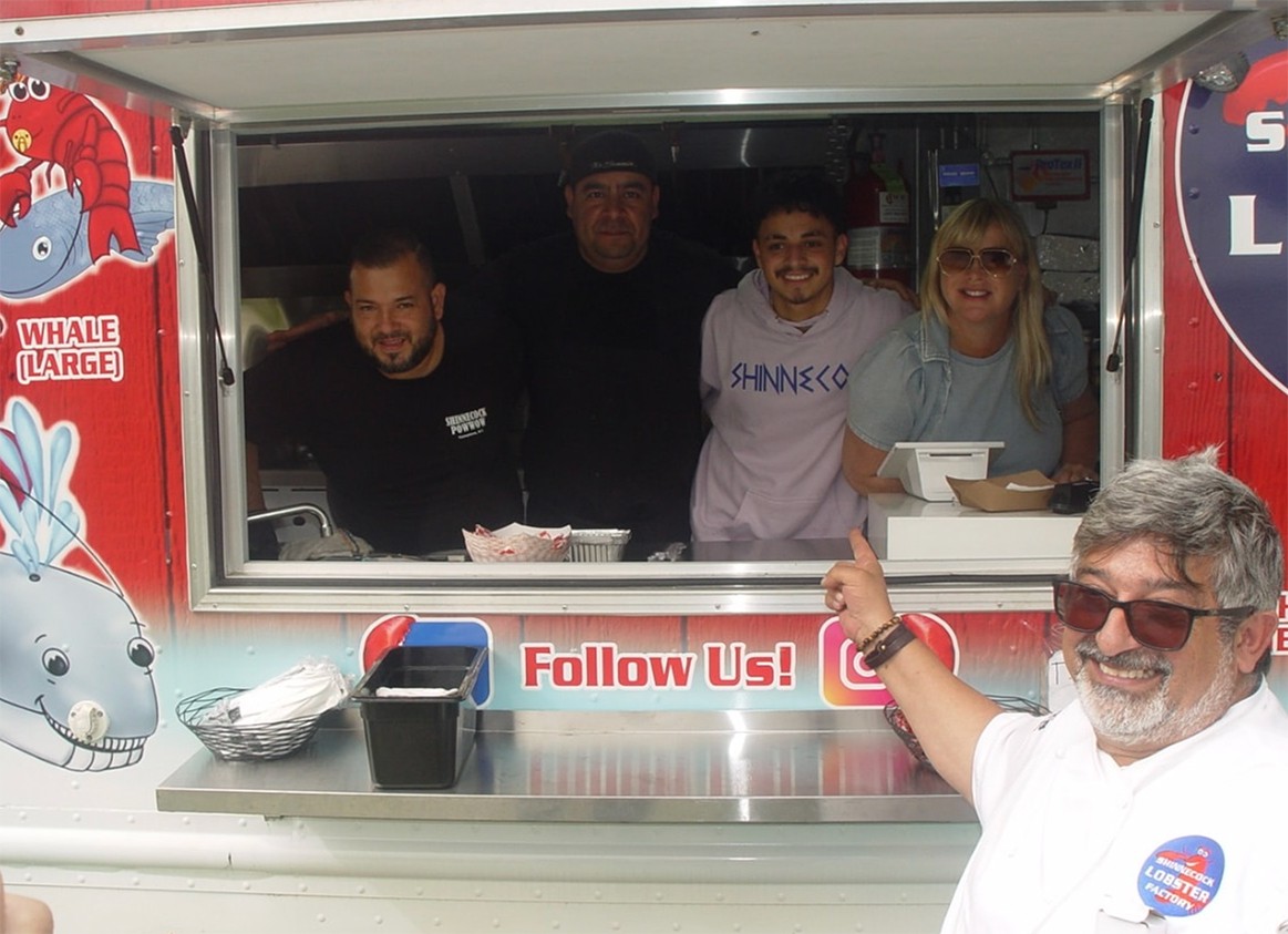Marco Barrila of Shinnecock Lobster Factory points to his team in the food truck