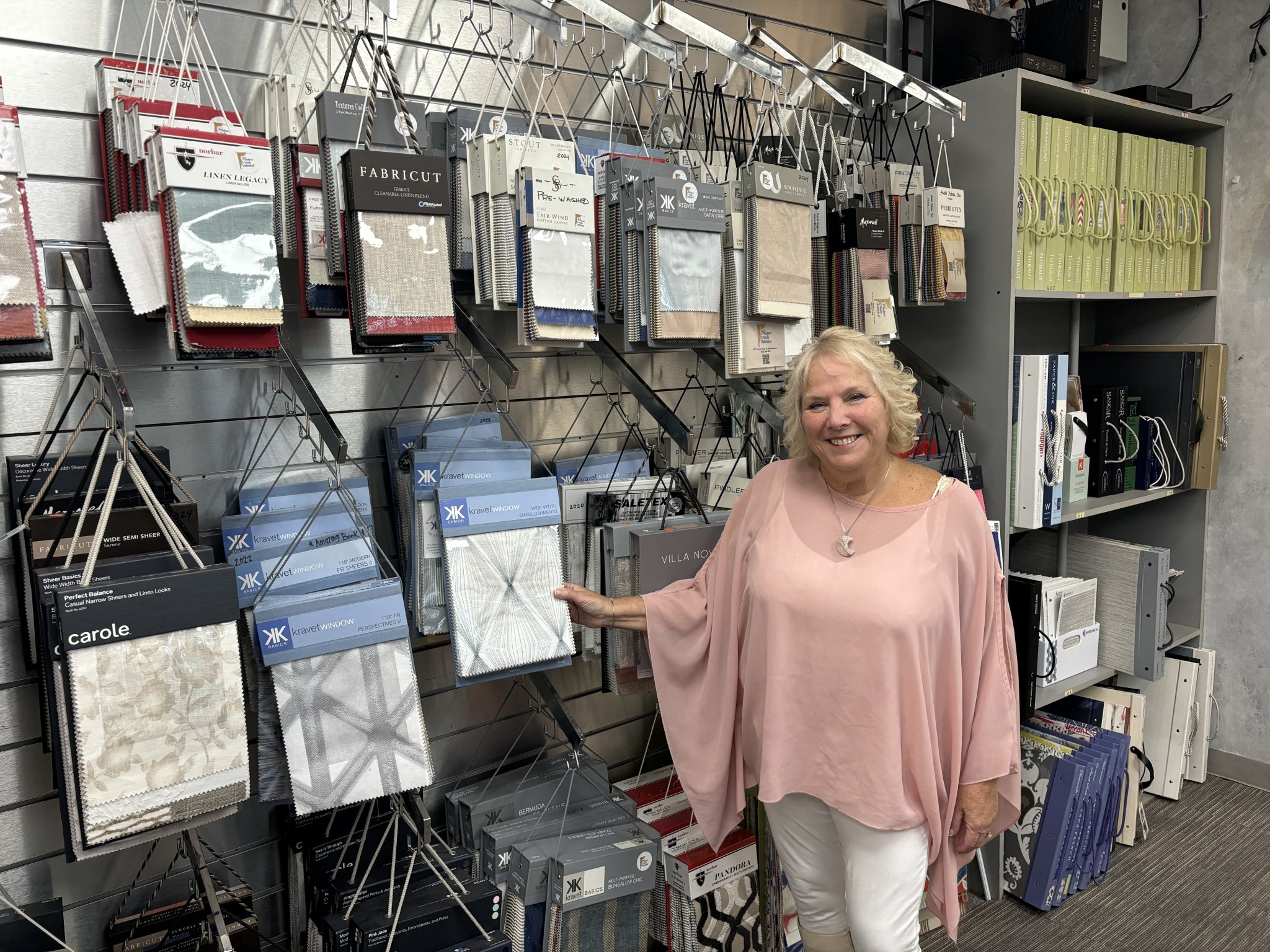 Linda Nuszen with some of the draperies offered at Windows & Walls Unlimited