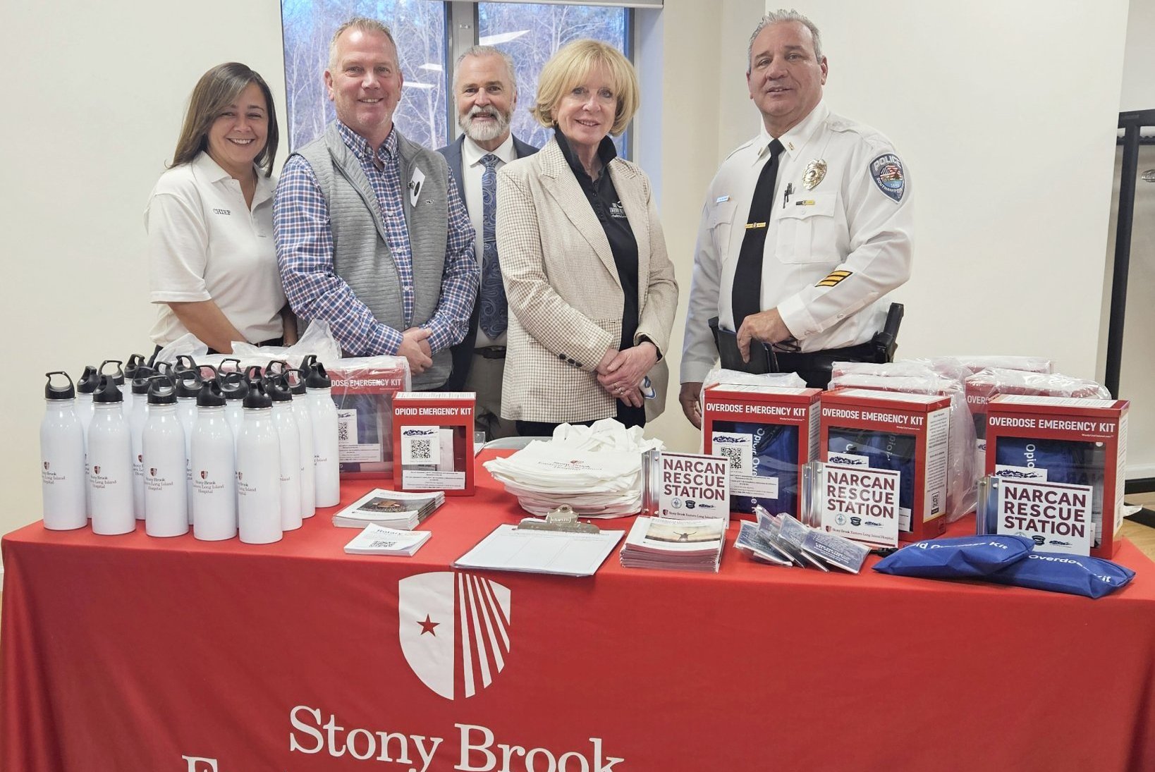 Chance Karr, Brian Babcock, Mark Strecker, Sheryl Heather, and Lt. Bill Kiernan with Narcan Rescue Station kits