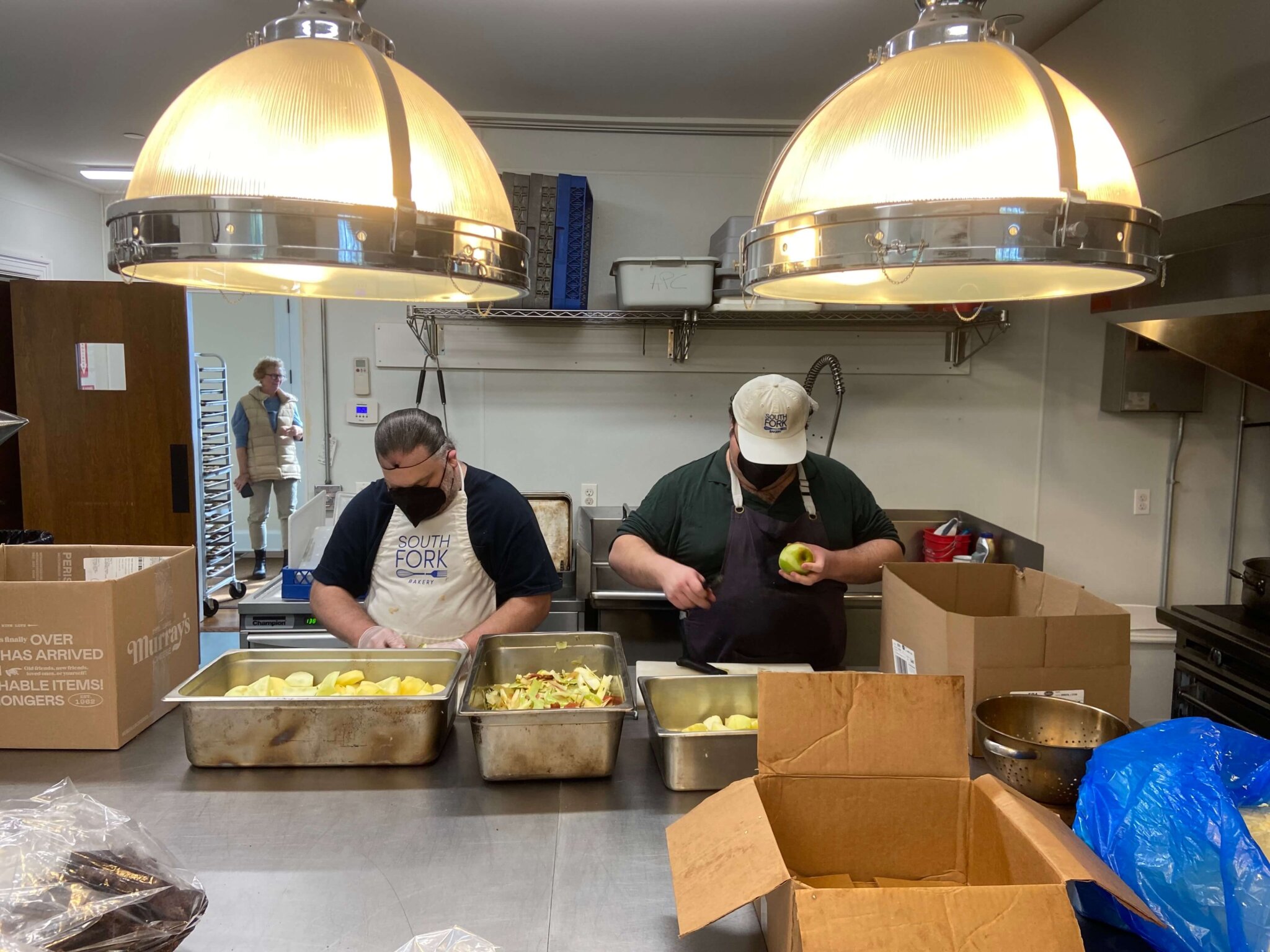 two men peeling apples at South Fork Bakery which provides meaningful employment opportunities for challenged adults